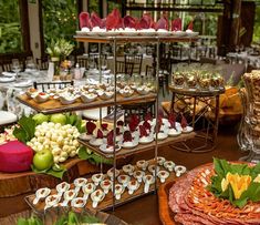 an assortment of desserts and pastries on display at a wedding or other function