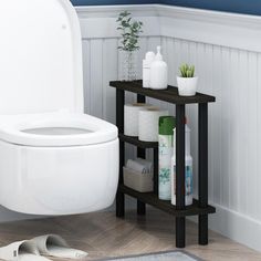 a white toilet sitting in a bathroom next to a wooden shelf