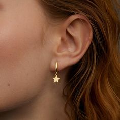 These 14k gold plated star hoop earrings are the perfect blend of elegance and simplicity. The dainty star charm adds a touch of celestial magic, making them an ideal accessory for any outfit. Crafted from hypoallergenic solid 925 sterling silver, these hoops are hypoallergenic and comfortable enough for all-day wear. Whether you're dressing up for a special occasion or adding a bit of sparkle to your everyday look, these earrings are a versatile must-have. Plus, they make a thoughtful gift for Glamour Jewelry, Star Hoop Earrings, Celestial Magic, Dainty Hoop Earrings, Jewelry Dainty, Celestial Jewelry, Gold Star, Gold Hoops, Star Charms