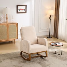 a living room with a rocking chair and side table