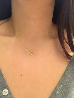 A delicate mini gold star necklace that's perfect for layering.  The little star charm is made of 24k gold over sterling silver.  This necklace looks great with any outfit whether it be at the office or a night out.  Very feminine and dainty. The perfect everyday piece of jewelry for your girlfriend, mom, sister, wife or just something everyday pretty for yourself!  This cute star necklace comes packaged in a beautiful gift box ready for gift giving.Each necklace is meticulously hand made in our Dainty Yellow Gold Star Charm Necklace, Delicate Yellow Gold Charm Necklace With Star Charm, Delicate Yellow Gold Star Charm Necklace, Cute Gold Jewelry With Star Charm, Dainty Star Charm Necklaces, Dainty Star Of David Charm Necklace With Delicate Chain, Dainty Star-shaped Personalized Necklace, Dainty Personalized Star Necklace, Dainty Star-shaped Necklace With Starfish Charm