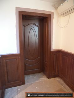 an empty room with wooden doors and no one in it