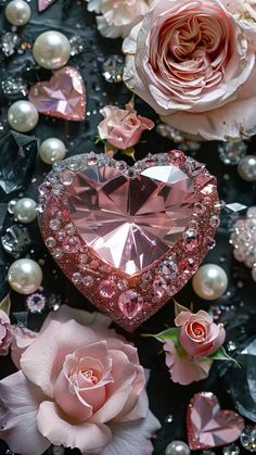 a pink heart shaped diamond surrounded by flowers and pearls on a black background with roses