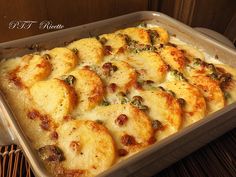 a casserole dish filled with cheese and vegetables