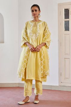 Yellow kurta with delicate ivory cord floral embroidery on the yoke, sleeves. Paired with pant, organza embroidered dupatta and slip.
Components: 4
Pattern: Embroidered
Type Of Work: Floral
Neckline: Round
Sleeve Type: Three quarter
Fabric: Chanderi Silk / Silk Organza
Color: Yellow
Other Details: 
Sheer panel detailing
Cutwork detailing
Occasion: Puja - Aza Fashions Yellow Kurta, Sets Outfit, Kurta Set For Women, A Line Kurta, Indian Lehenga, Embroidered Dupatta, Animal Photos, Thread Embroidery, Summer Suits