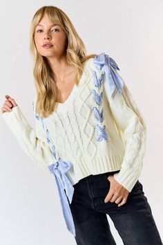 The cutest, demure satin bow cable knit v-neck sweater. Features blue satin sewn ribbons braided into sweater. Ribbon Sweater, Swim Jewelry, Grad Outfits, Butterfly Sweater, Ribbon Braids, Bow Sweater, Cream Knit Sweater, Fairy Clothes, Satin Bow