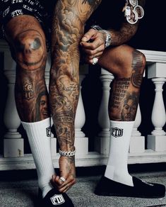 a man with tattoos on his legs and feet