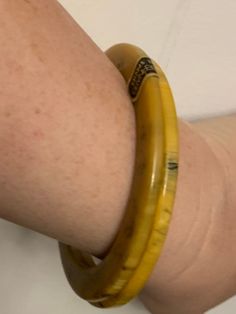 These gorgeous bangles came from a Maryland estate and are a rare find indeed! These appear to be marbled Bakelite bracelets made by Les Bernard, most likely in the early 70's. Each bangle features beautiful butterscotch yellow marbling, accented with a dark greenish hue. One of the bangles has the original sticker still on it. These bracelets are approximately 3.35 inches across, with an inner diameter of approximately 2.4 inches. The width of each bangle when laying flat is approximately 0.4 i Adjustable Yellow Round Bangle, Vintage Yellow Round Bracelets, Yellow Bangle Bracelets For Formal Occasion, Retro Yellow Bangle Bracelets, Retro Yellow Bangle Bracelet, Yellow Vintage Bracelet As Gift, Bakelite Necklace, Twist Beads, Bakelite Bracelets