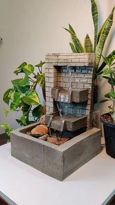 a fountain made out of bricks on top of a table