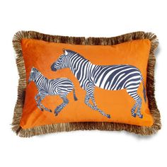 an orange pillow with two zebras on it