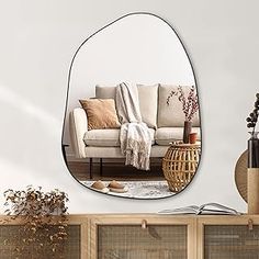 a living room filled with furniture and a large mirror