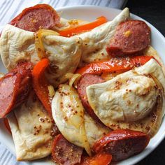 a white plate topped with meat and veggies