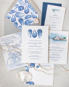 the wedding stationery is laid out on top of each other, including an envelope and two