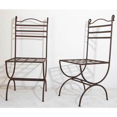 two metal chairs sitting next to each other