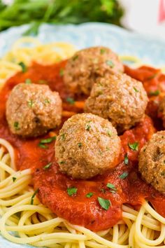 spaghetti with meatballs and tomato sauce on it