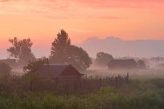 a farm house in the middle of a foggy field