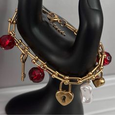 This super gorgeous gold charm bracelet is made pearls, red crystal beads stainless steel gold heart, key and heart charm pendants linked to a beautiful stainless steel ball chain.  Perfect as a gift for your loved ones or yourself. The charm pendants is set along th stainless steel ball chunky chain. It's 18 carat gold plated tarnish resistant nickel free.   This bracelet is a classic statement elegant piece that draws all attention to the crystal red beads and charm as it sparkles.  This beautiful piece can be worn both dressed or casual. Make a statement with this classy piece. Can be paired with our other bracelets.  Also available in silver. see link https://tarocollection.etsy.com/listing/1672251493 The quantity is limited. Grab yours now! Handmade with love ❤️ Cheap Handmade Red Charm Bracelet, Chain Charm Bracelet, Valentines Bracelets, Beads Charm, Bracelet Pearl, Heart Key, Red Beads, Gold Charm Bracelet, Wrist Cuffs