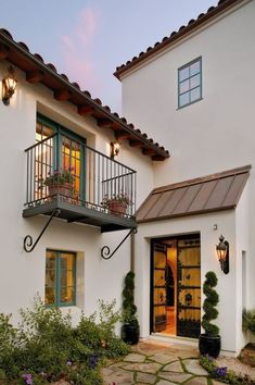 a white house with green shutters and windows