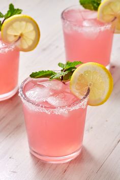 three glasses filled with pink lemonade and mint garnish