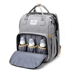 a diaper bag with three bottles in it and an inserted bottle pocket on the side