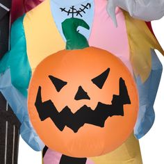 an inflatable halloween pumpkin balloon is being held by someone's arm and head