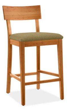 a wooden bar stool with a green upholstered seat and back cushion on an isolated white background