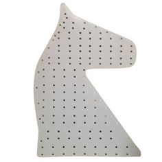 a white horse shaped object with dots on it