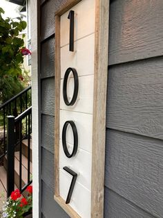 a house number sign mounted to the side of a building