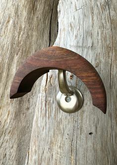 a wooden door handle with a metal ball on it