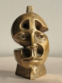 a bronze sculpture with two faces on it