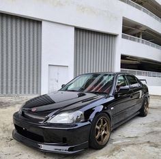 a black car parked in front of a building