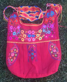 "This is a beautiful embroidered bag handmade by Mexican Artisans With elegant multi-colored designs and patterns Each embroidered bag takes about 10 hours to make Straps are made with macrame technic The strap is long enough to wear as a simple over the shoulder or as a crossbody Every bag is unique made with ancestral techniques Excellent gift for any occasion Due to the hand made nature of this item the embroidered colors and patterns may vary **HAND WASH ONLY** Follow and tag us on instagram Traditional Multicolor Bag With Adjustable Strap, Multicolor Floral Embroidered Shoulder Bag For Travel, Multicolor Floral Embroidery Shoulder Bag For Travel, Traditional Bag With Multicolor Embroidery And Adjustable Strap, Rectangular Bag With Multicolor Embroidery And Hand-stitched Details, Red Embroidered Bag For Daily Use, Pink Embroidered Bohemian Shoulder Bag, Traditional Bags With Floral Embroidery For Daily Use, Pink Bohemian Embroidered Shoulder Bag