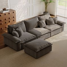 a living room with a sectional couch and ottoman