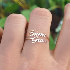 a woman's hand with a ring that says, emma grace on the side