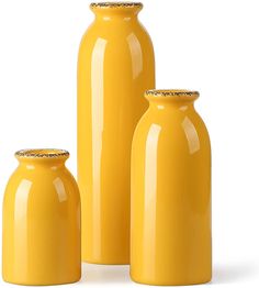 three yellow vases sitting next to each other