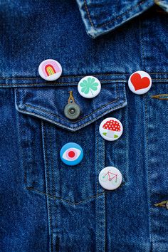 several buttons are placed on the back of a jean jacket