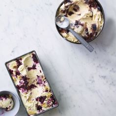 two pans filled with ice cream on top of a white counter next to each other