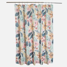 a floral curtain hanging on a metal rod