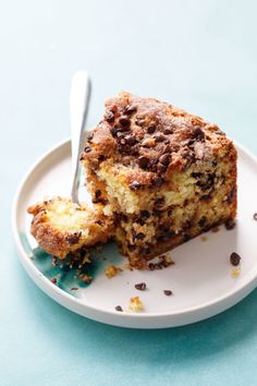 a piece of chocolate chip coffee cake on a white plate with a bite taken out