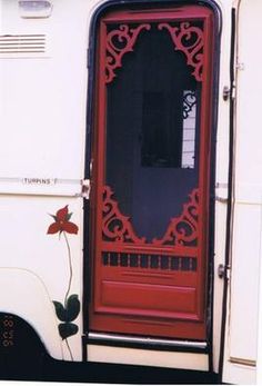 a red door on the side of a white truck