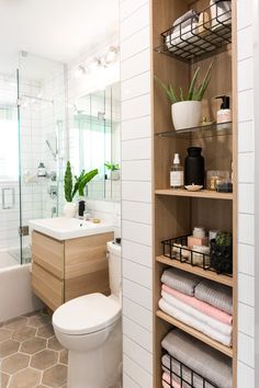 the bathroom is clean and ready to be used as a storage area for towels, toiletries, and other items