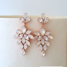 a pair of earrings on top of a white box