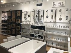 a room filled with lots of different types of sinks and faucets in it