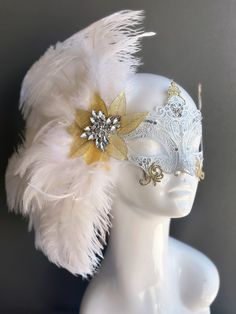 Our women's white laser cut metal masquerade mask, adorned with delicate white feathers and a gold crystal brooch, offers you the opportunity to add a touch of enchanting gold glitter to the mask. Whether you're attending a grand masquerade ball, a themed gala, or simply looking to add a touch of elegance to your attire, this mask ensures you'll be the center of attention.


Age Group/Gender - Adult/Women

Size/Type - One size fits all adults

Mask Color - White

Mask Material - Laser cut metal Elegant Wedding Masks, Elegant Gold Masquerade Mask For Wedding, Elegant Headpieces For Masquerade Carnival, Elegant Headpieces For Carnival Masquerade, Elegant Feathered Masquerade Mask For Mardi Gras, Elegant Feathered Masquerade Mask, Elegant Feathered Eye Mask For Masquerade, Elegant Gold Masquerade Mask, Gold Elegant Headpiece For Mardi Gras