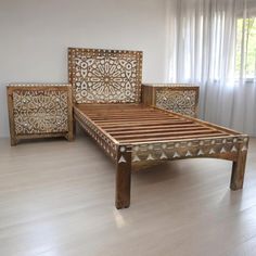 a wooden bed frame sitting on top of a hard wood floor