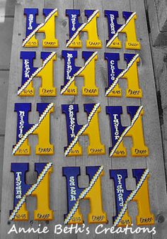 some yellow and blue letters are sitting on a wooden table next to a black and white photo