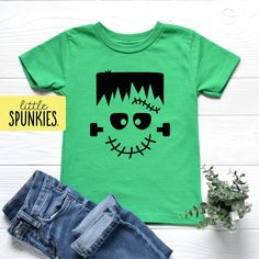 Frankenstein Face Graphic Tee, Boys Halloween T-Shirt, Green Monster Shirt PRODUCTION TIME Little Spunkies from the designer/owner of Spunky Pineapple Co https://www.etsy.com/shop/SpunkyPineappleCo  All baby and toddler clothes are 100% designed and printed with water based inks by us at our shop. All orders placed before 12:00 pm EST are shipped out same day (Monday - Friday). Orders received after noon are shipped out the next business day. SIZING Please see images for size chart details. Todd Green Themed T-shirt With Short Sleeve, Themed Green Short Sleeve T-shirt, Green Themed Short Sleeve T-shirt, Fall Themed Short Sleeve T-shirt, Themed Green Crew Neck Top, Green Themed Crew Neck Top, Green Halloween T-shirt With Character Print, Frankenstein Face, Monster Shirt