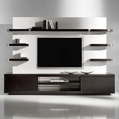 a modern entertainment center with shelves and a flat screen tv