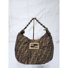 This Authentic Fendi Zucca Canvas Mia Hobo Bag Brown Is In It’s Good Pre-Owned Condition. The Exterior Is Clean And Beautiful. Interior Is Clean. There Are Minor Scratches To The Hardware (Kindly Look At Pictures Above). Kindly Note That Picture On Mannequin Is Not Ours But For Size Reference And Fit. Dimensions Base Length: 14.5” Height: 10.25” Width: 3.75” Drop: 8.25” Fendi Bags, Hobo Bag, Brown Color, Fendi, Bag Lady, Exterior, Canvas