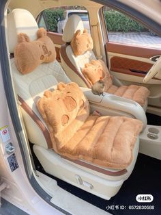 two teddy bears sitting in the back seat of a car